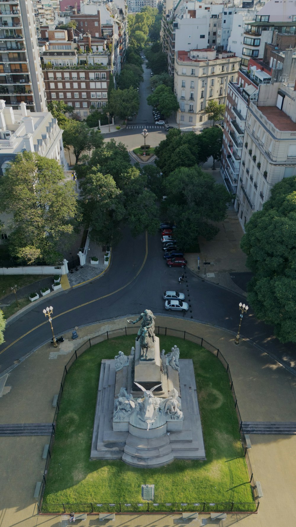 an aerial view of a city with a statue in the center