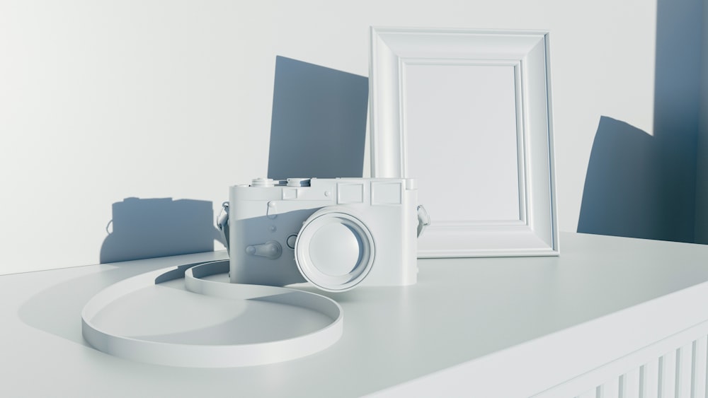 a white camera sitting on top of a white table