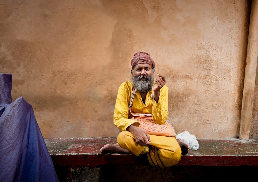 a man with a turban sitting on a bench