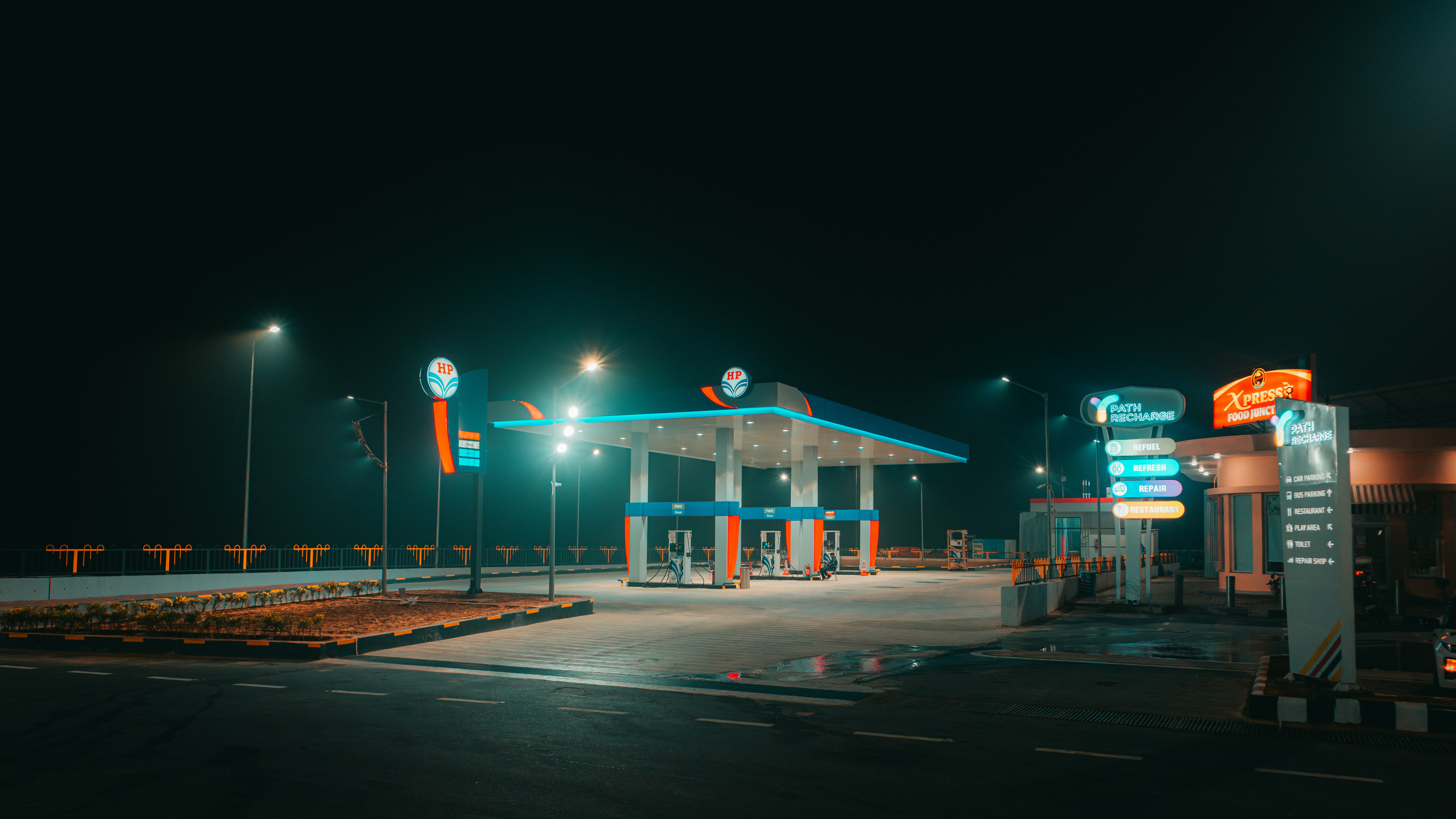 a gas station at night with lights on