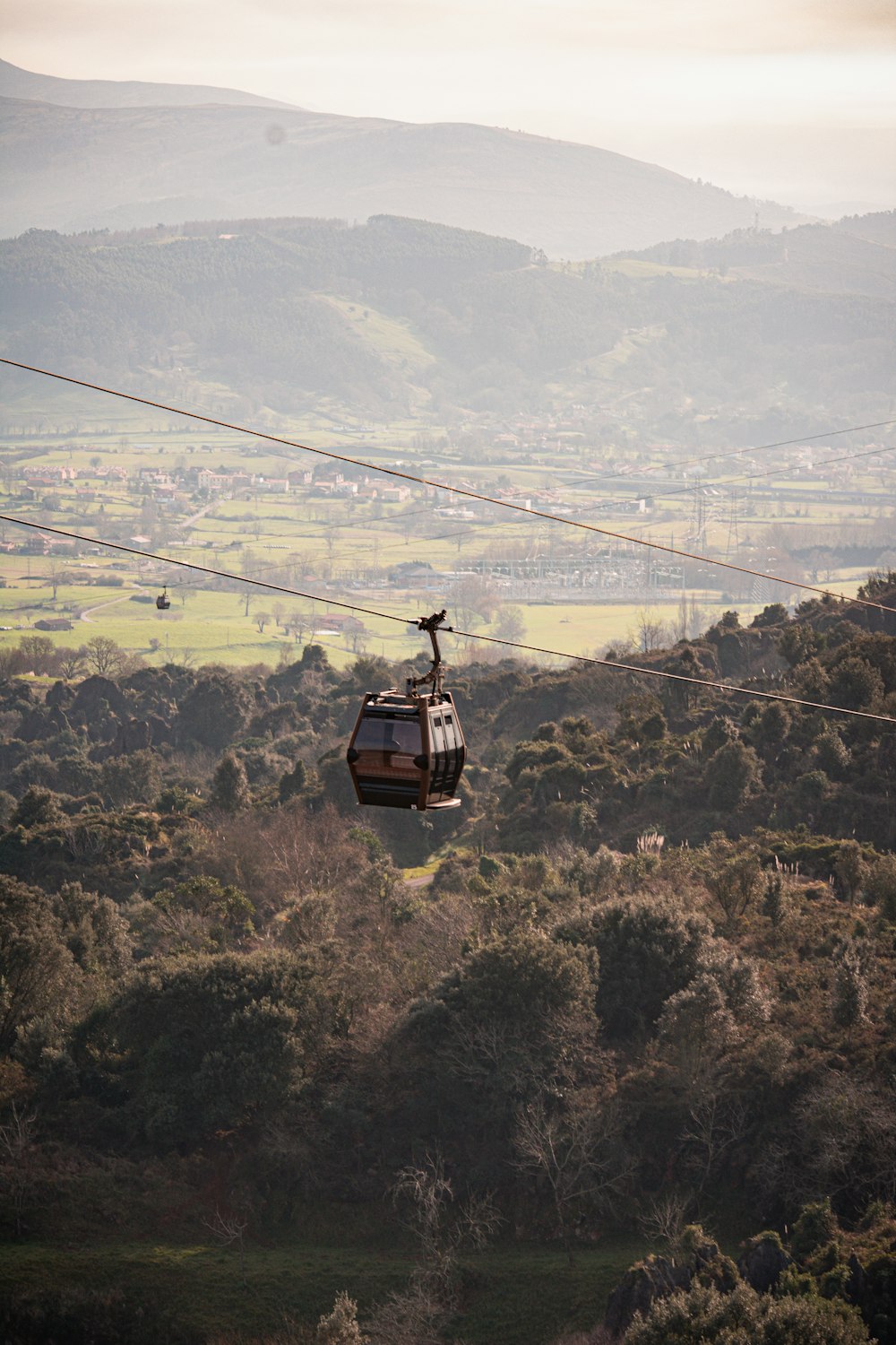 a gondola with a view of a valley below