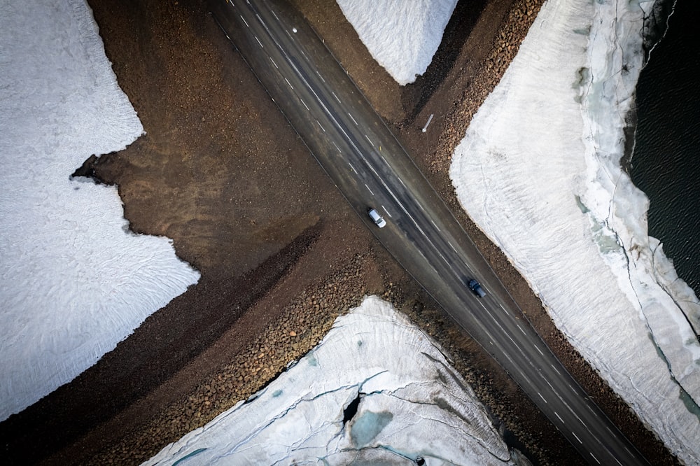 an aerial view of a road in the snow