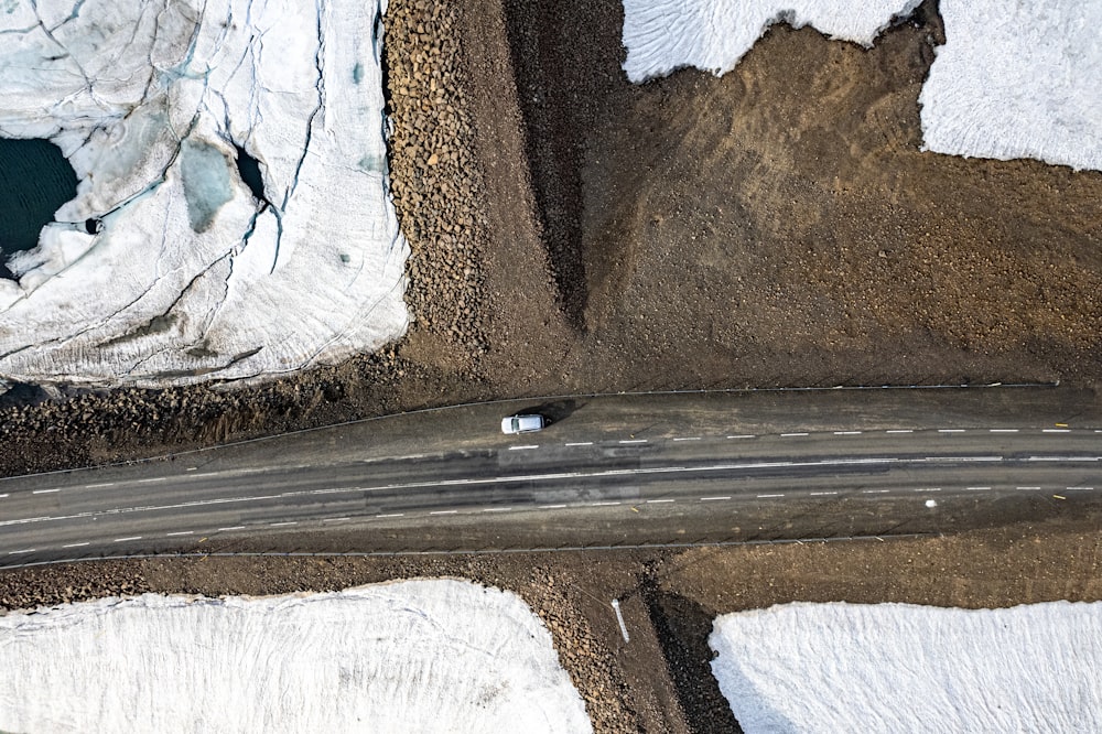 an aerial view of a road in the snow