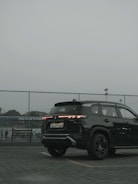 a black suv parked in a parking lot