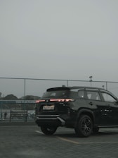 a black suv parked in a parking lot
