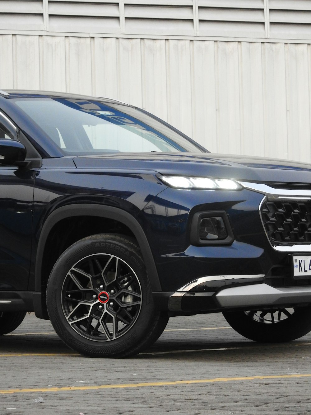 a black suv parked in front of a building