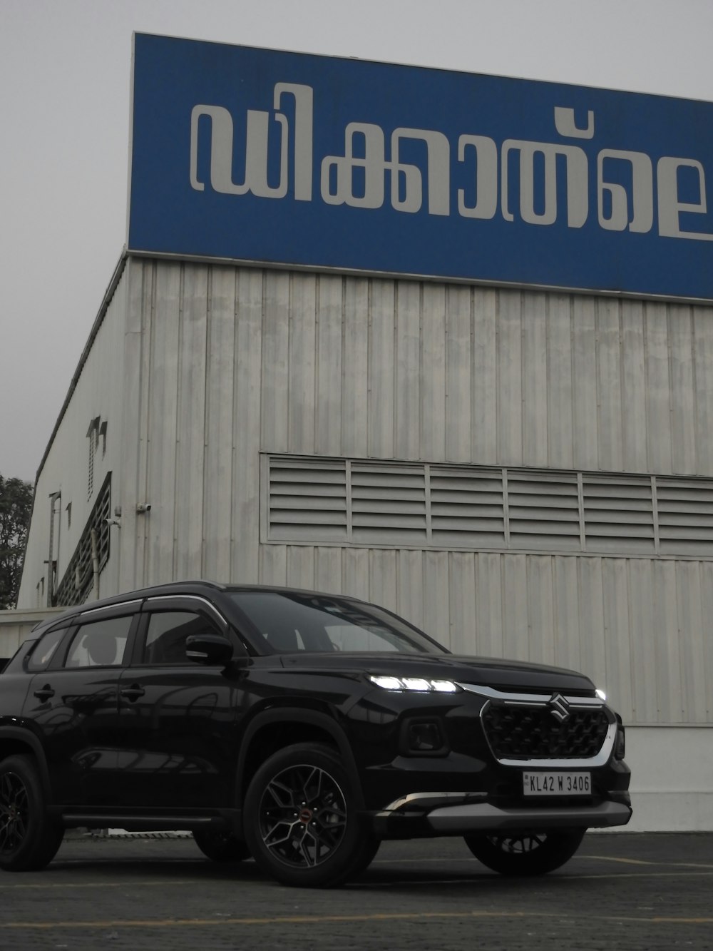 a black suv parked in front of a building