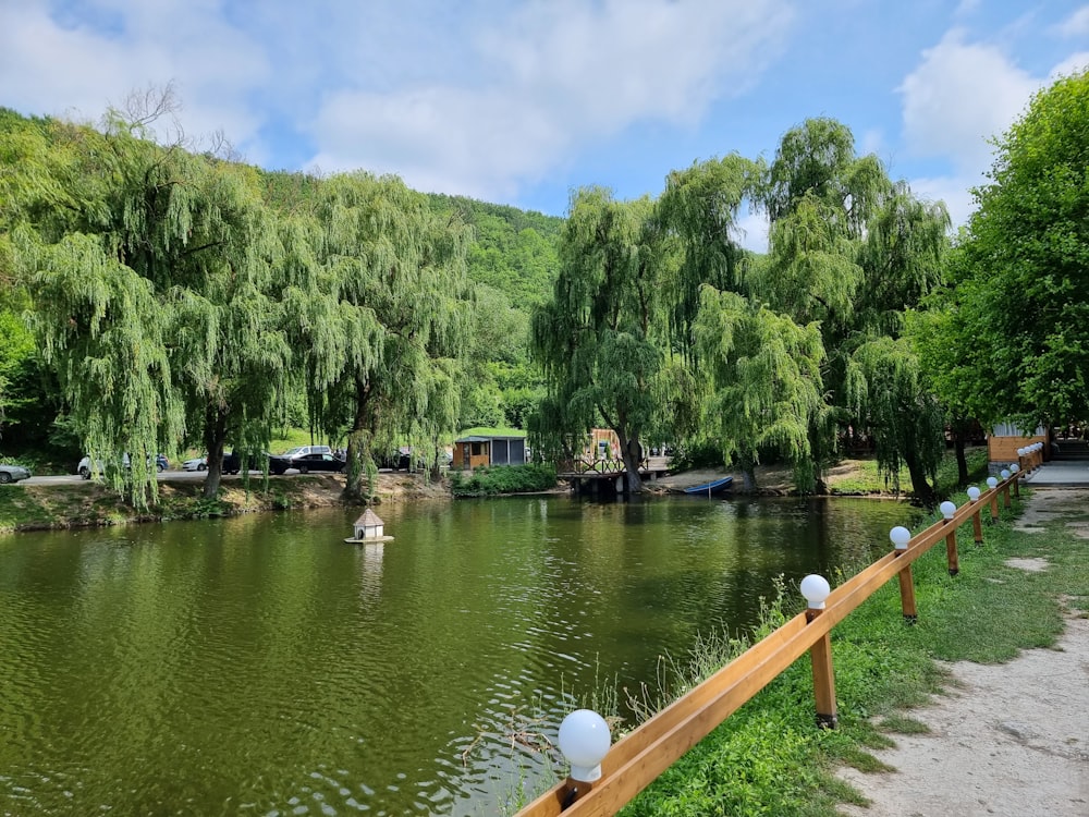 a river with a wooden fence next to it