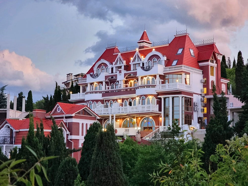 a large red and white house surrounded by trees