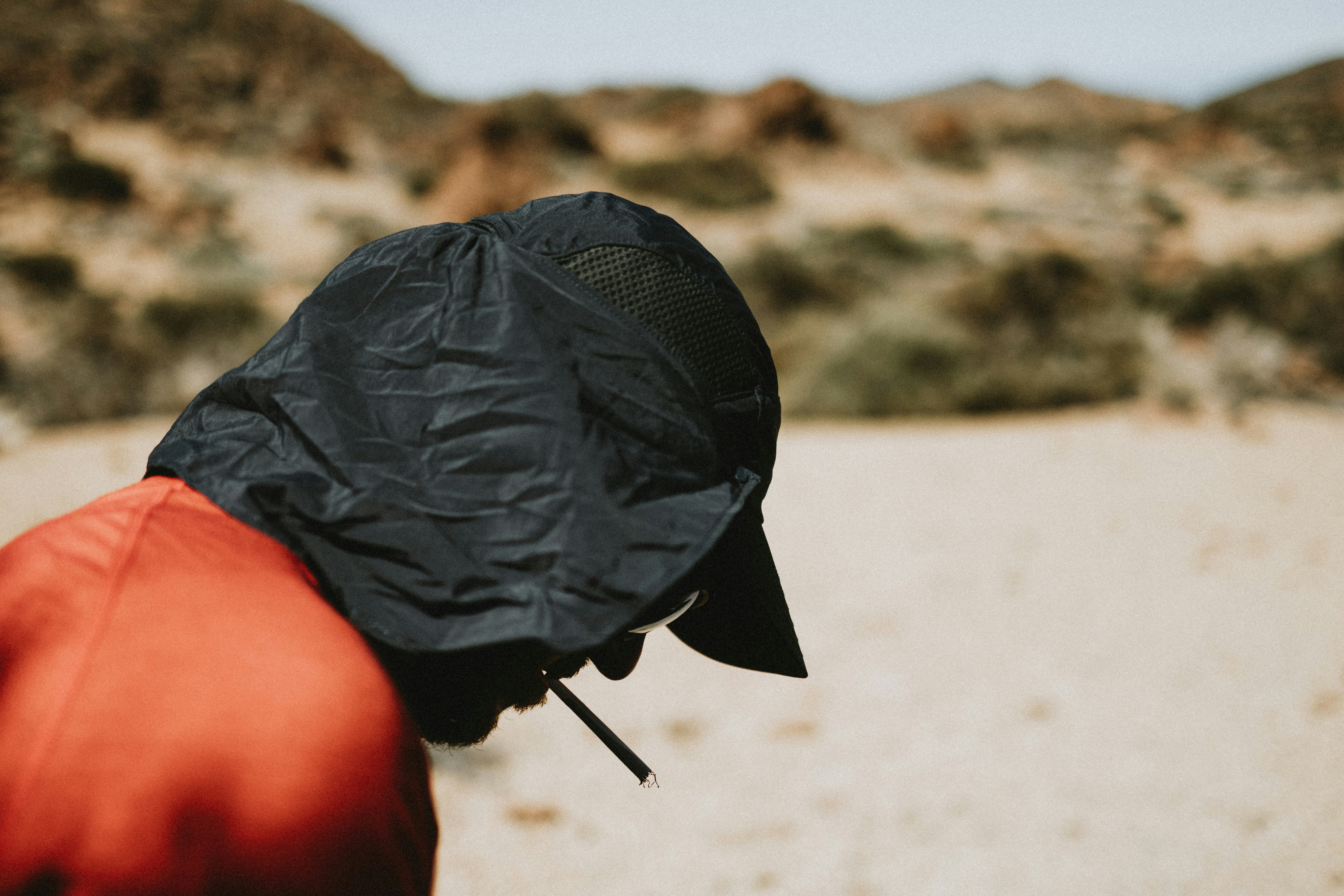 a person wearing a black hat and a red jacket