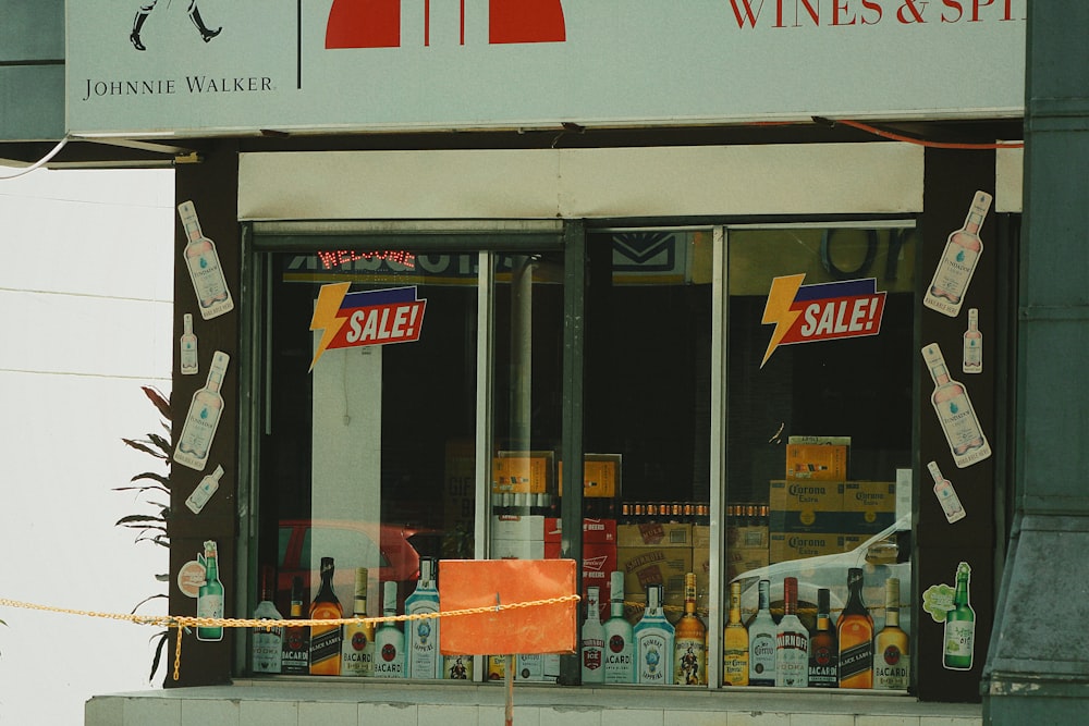 a store front with a sale sign taped to the window