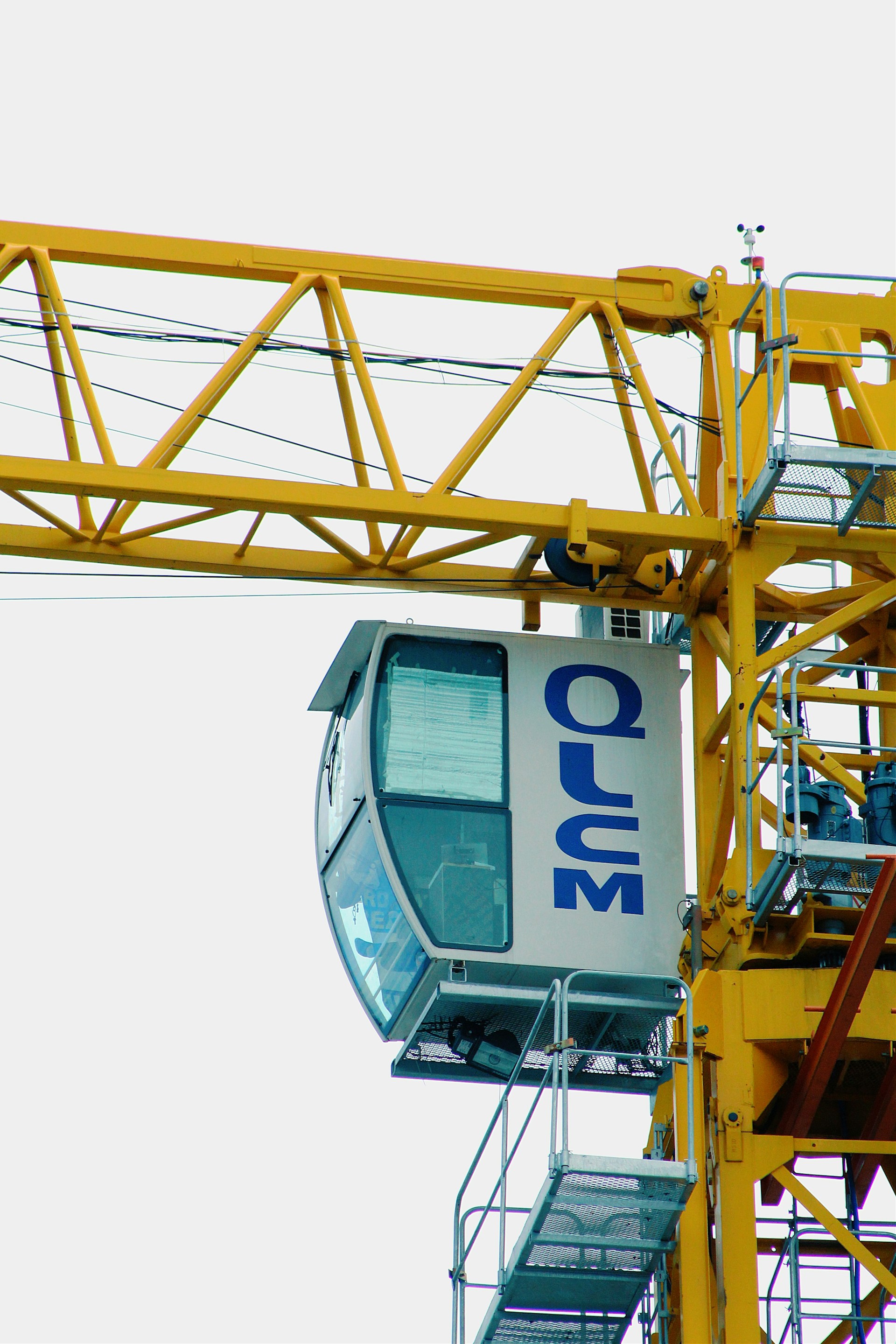 a yellow crane with a blue sign on it