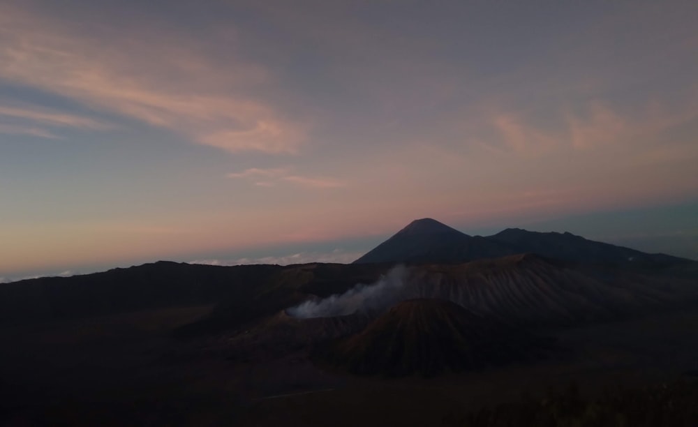 a view of a mountain with steam coming out of it