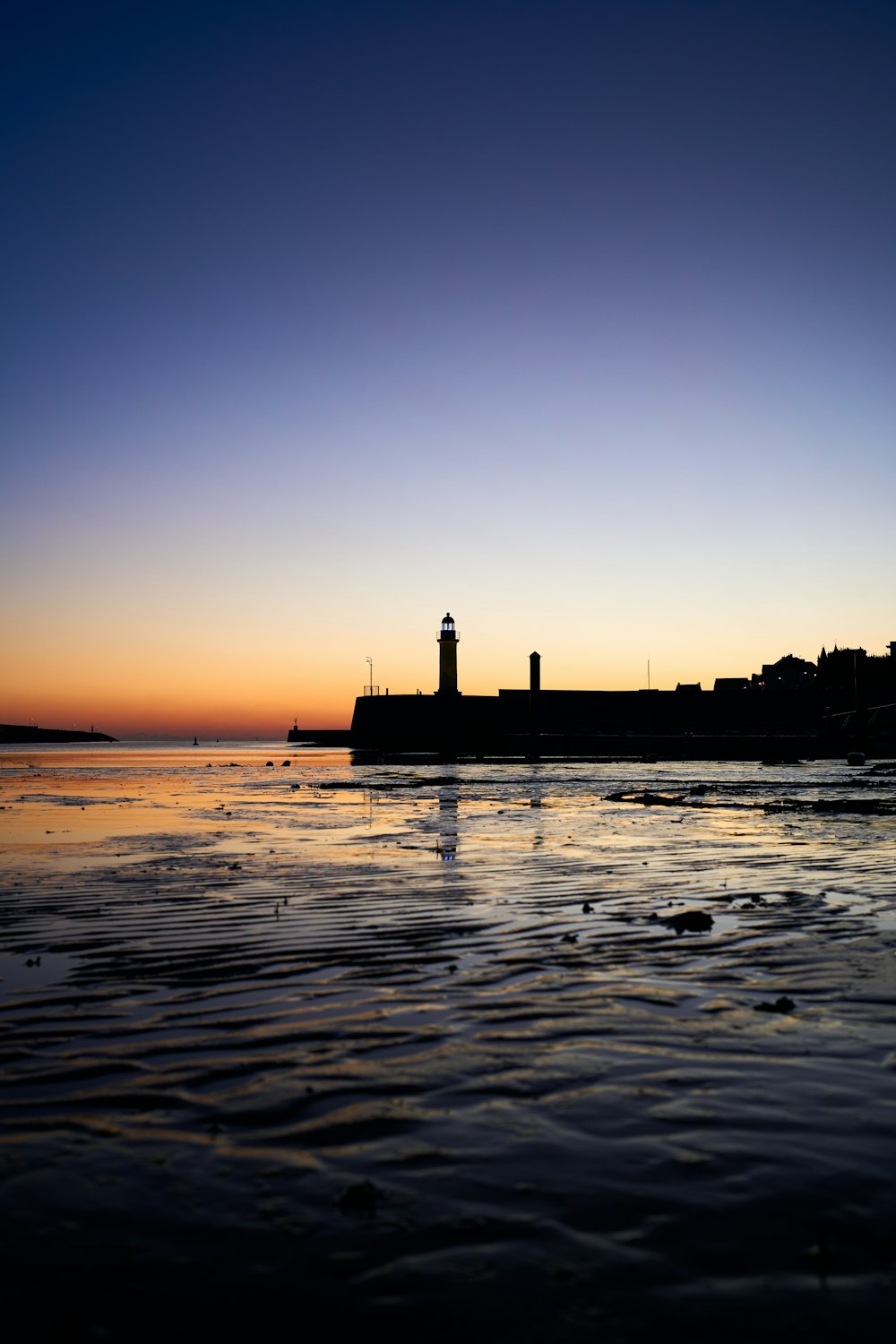 a view of a body of water with a lighthouse in the distance