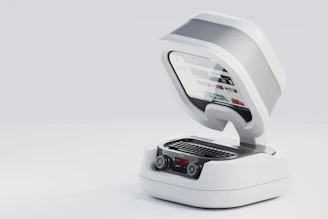 a white machine with a laptop on top of it