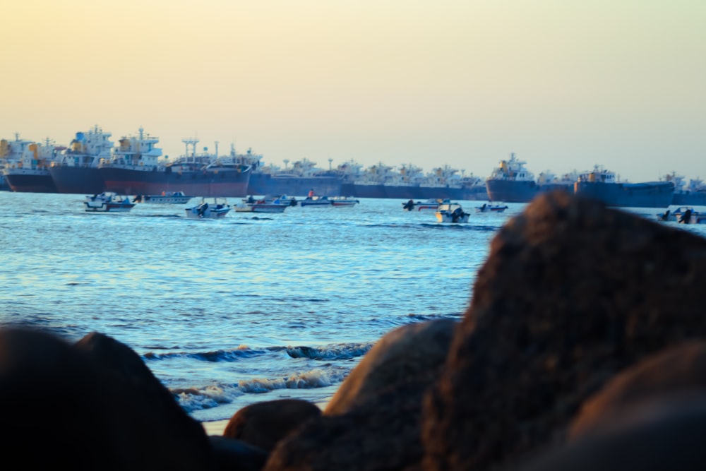 a group of boats floating on top of a body of water