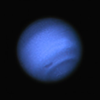 a large blue object in the dark sky