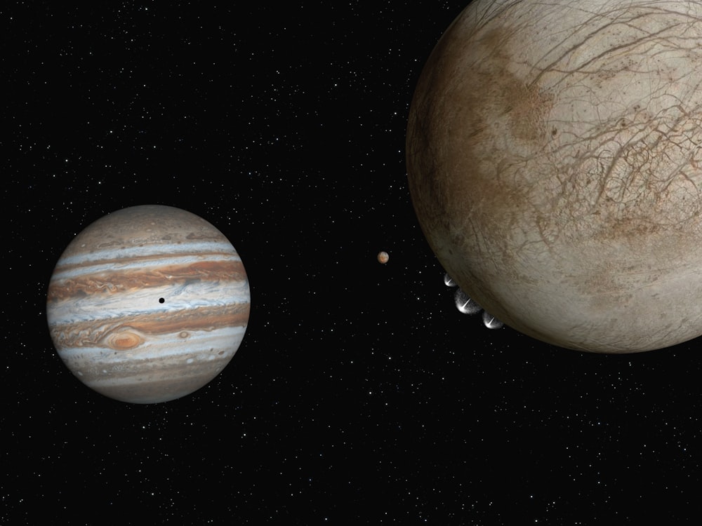 two planets are shown in the dark sky