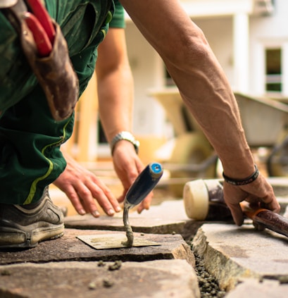 a man working on a piece of concrete