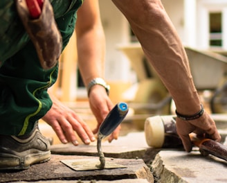 a man working on a piece of concrete