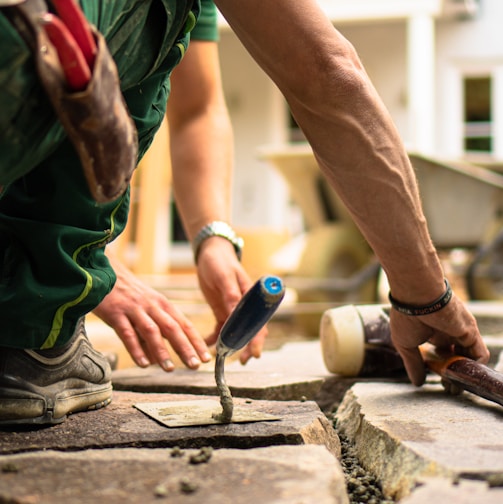 a man working on a piece of concrete