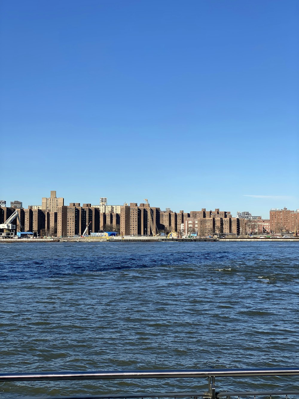 a large body of water with a city in the background