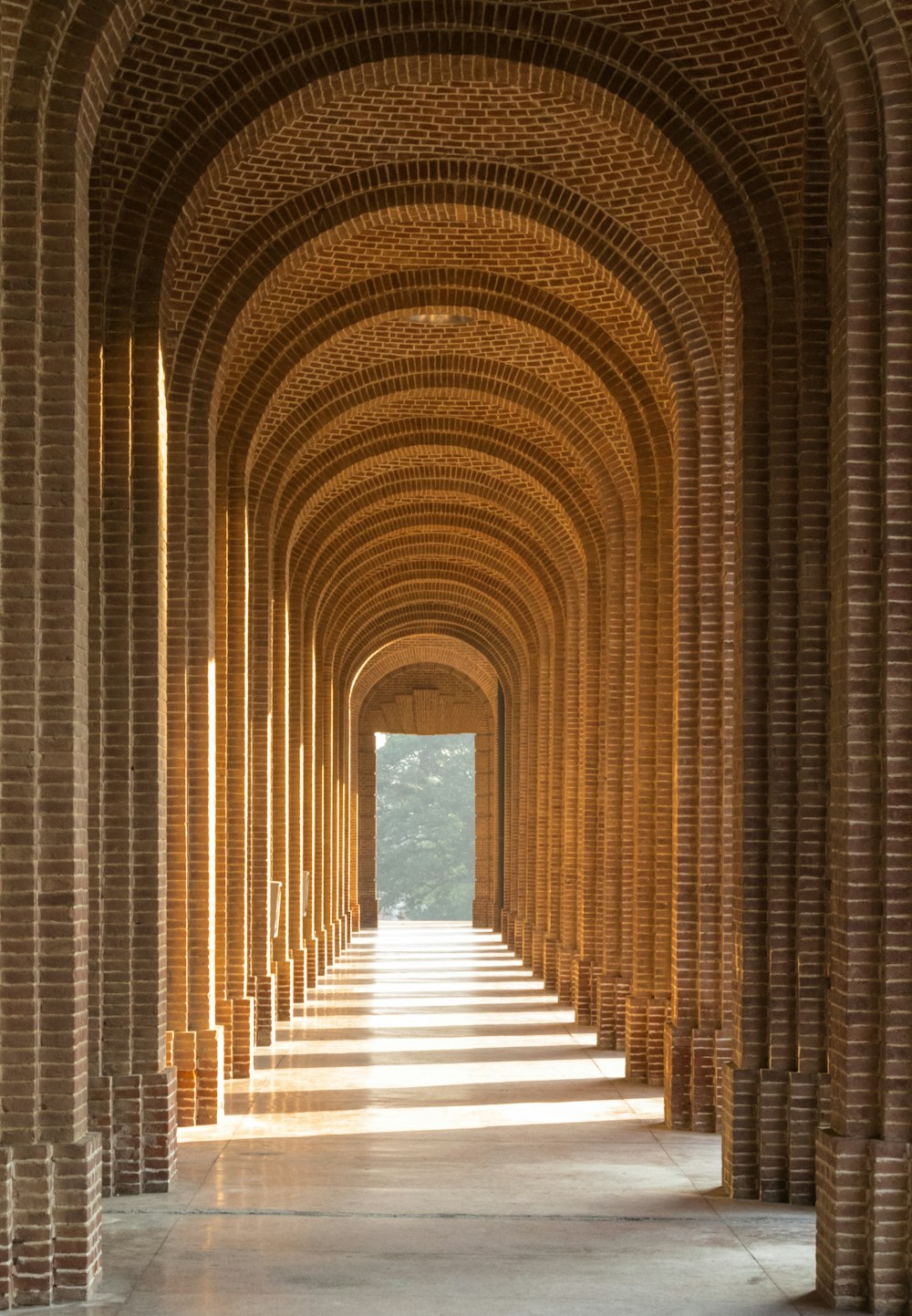 a walkway lined with columns and pillars in a building