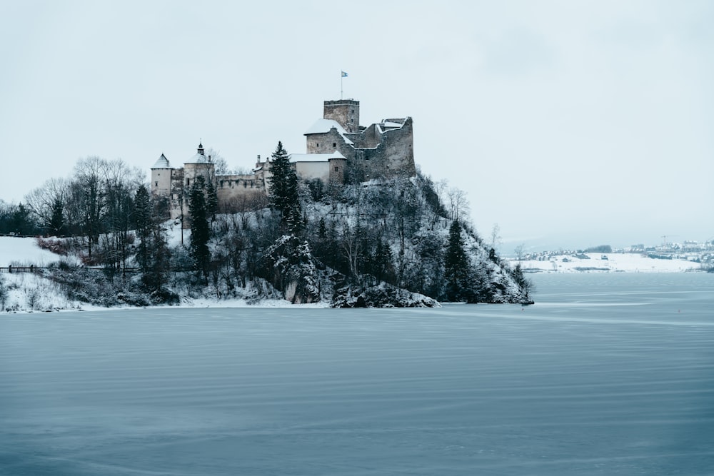 a castle sitting on top of a snow covered hill