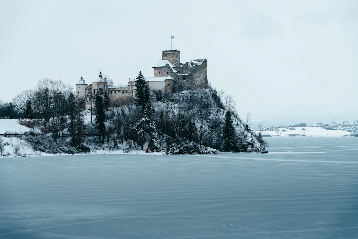 A castle sitting on top of a snow covered hill