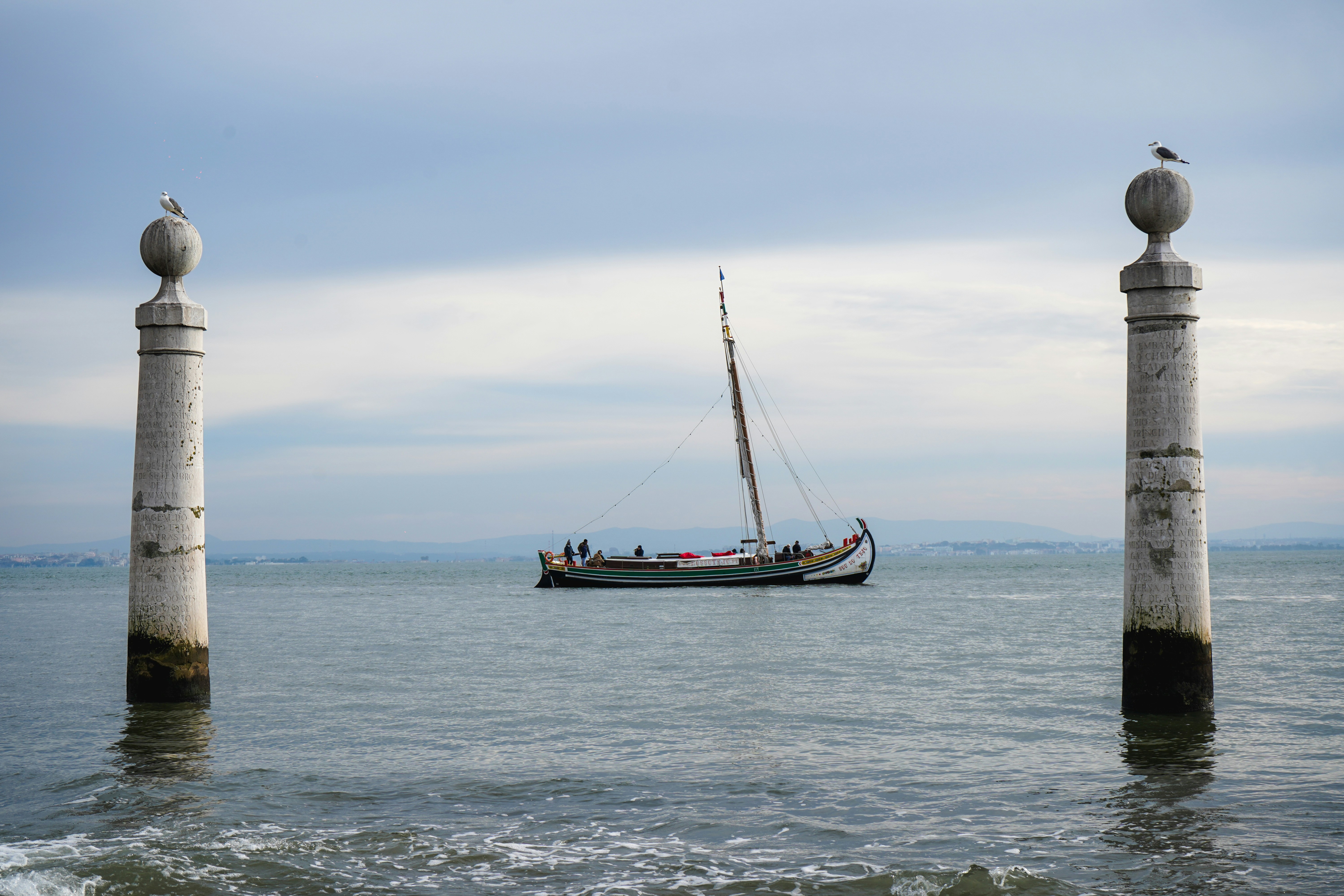 a sailboat in the ocean with a bird sitting on top of it, 