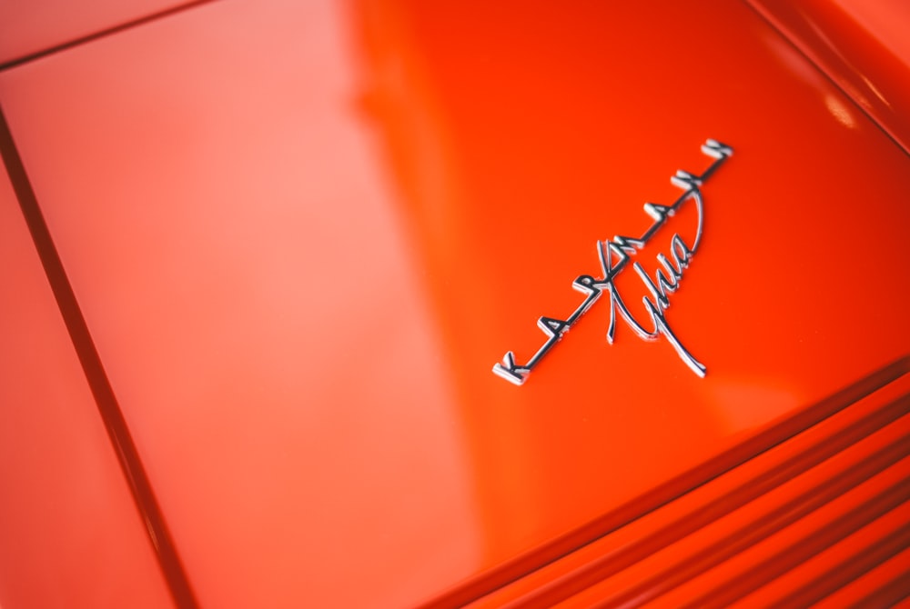 a close up of the emblem on a red car