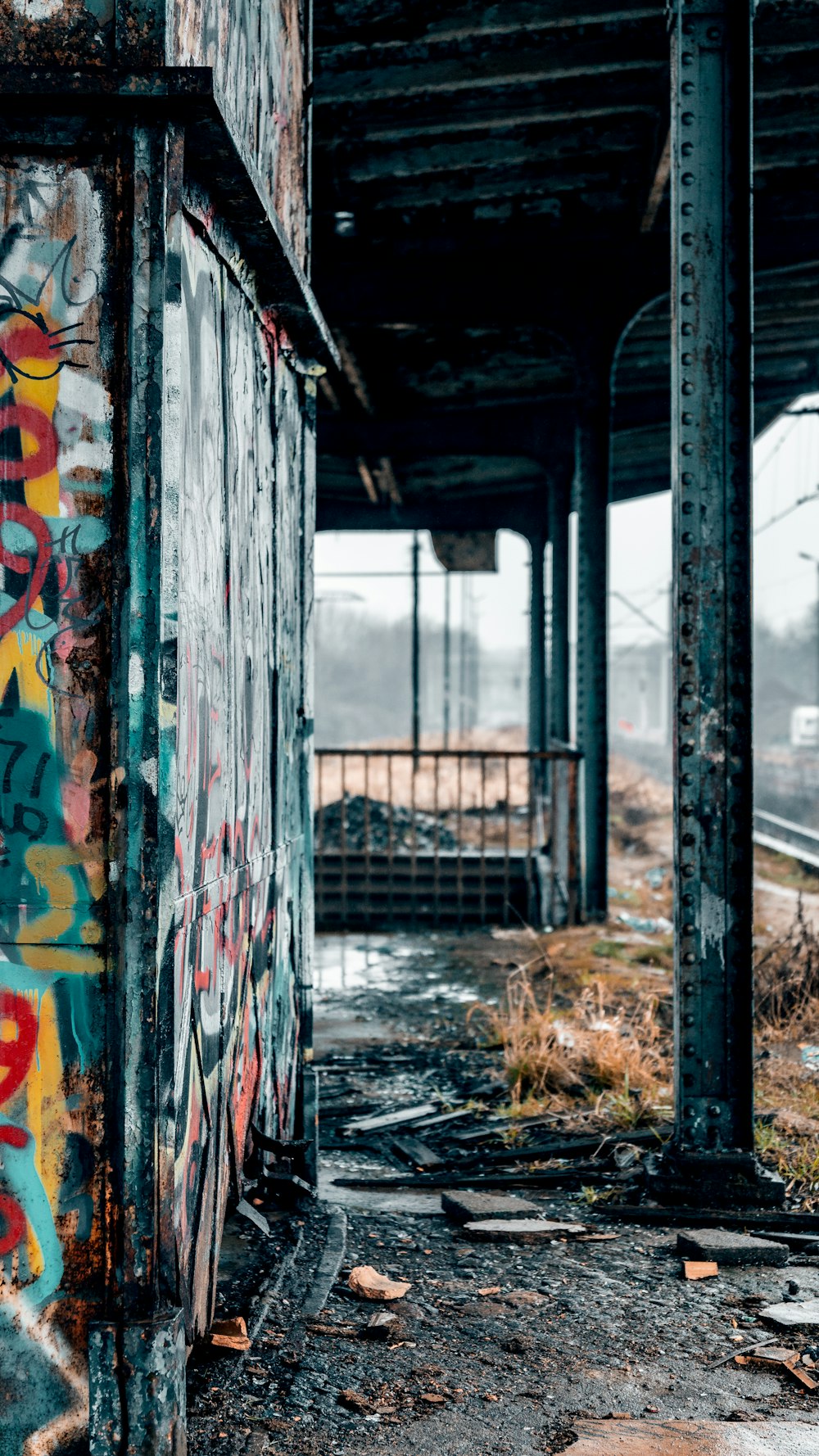 a train station with graffiti on the side of it