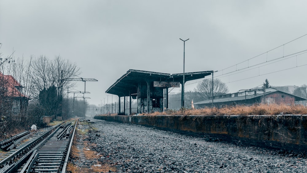 a train station sitting on the side of a train track