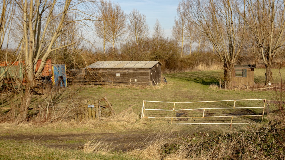 a farm yard with a barn and a gate