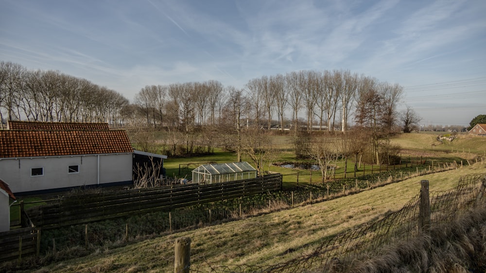 a farm with a fence and a barn
