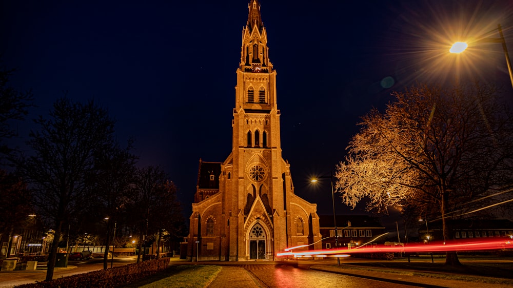 a church lit up at night with a long exposure