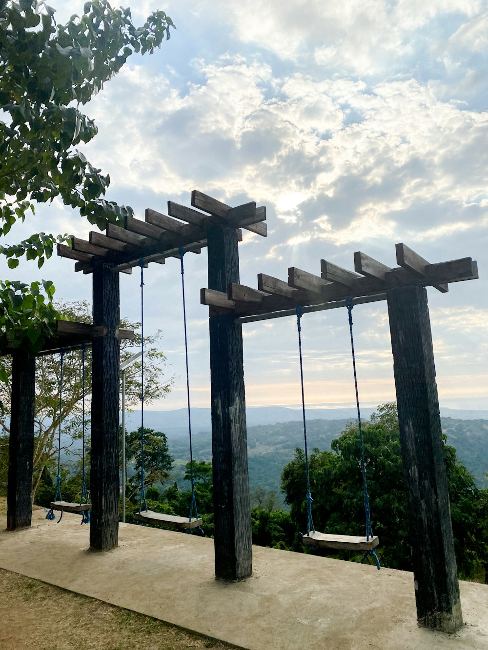 a couple of wooden swings sitting next to each other