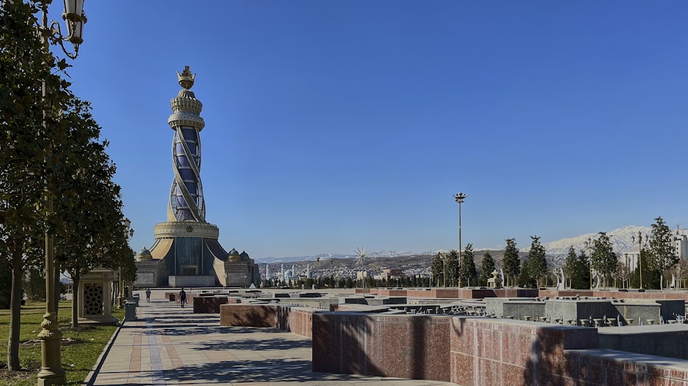 a monument with a light tower in the background