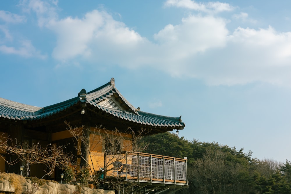 a building with a green roof and a balcony