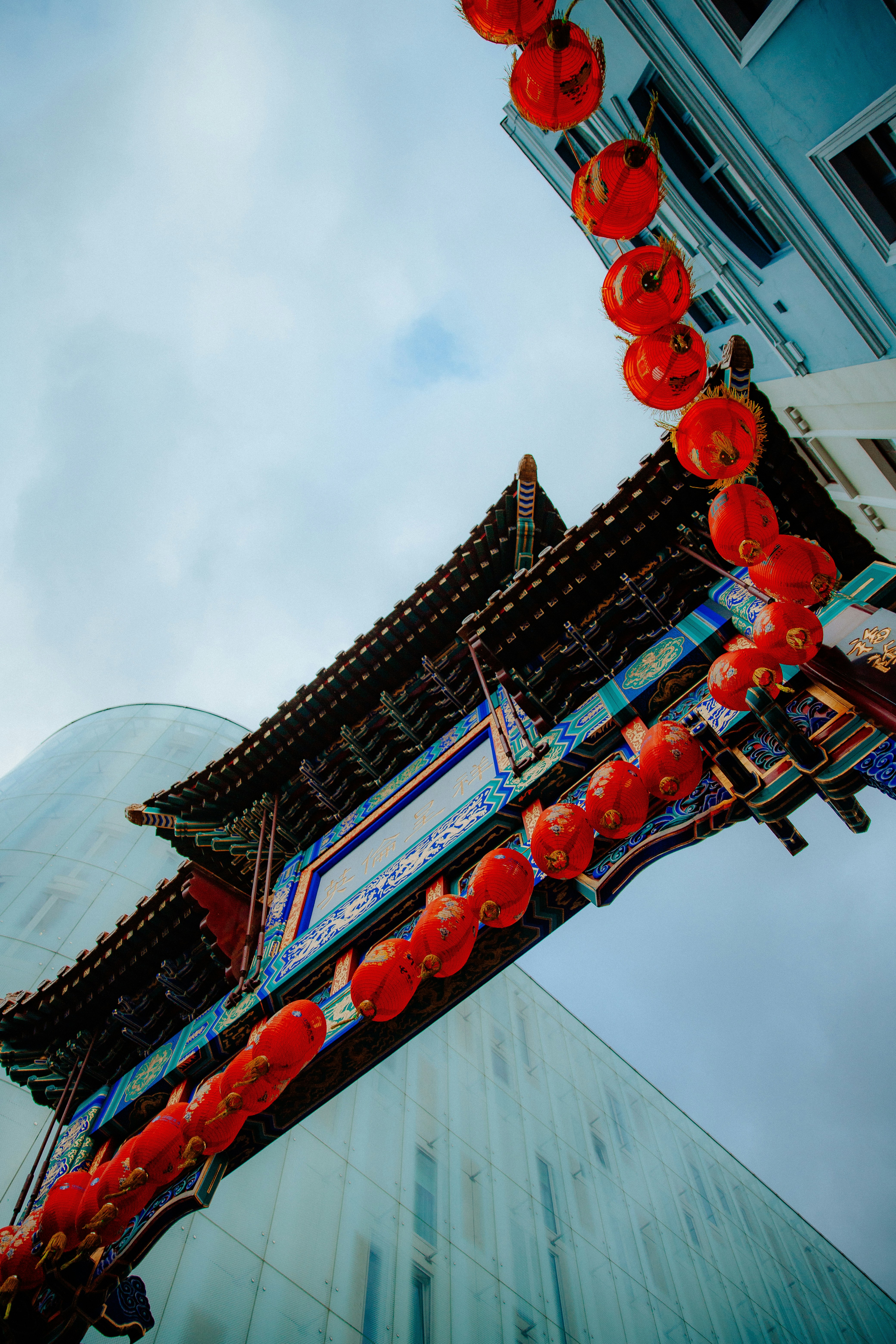 a tall building with red lanterns hanging from it's sides