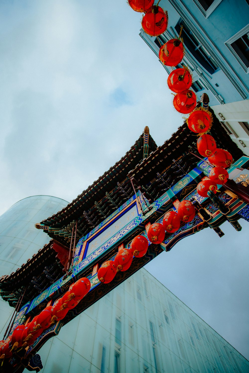a tall building with red lanterns hanging from it's sides