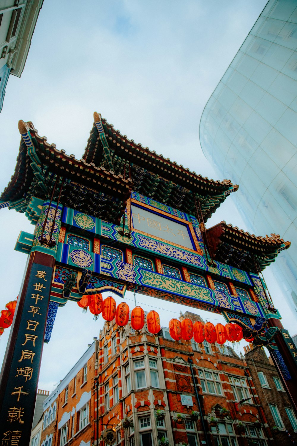 a tall building with chinese decorations hanging from it's sides