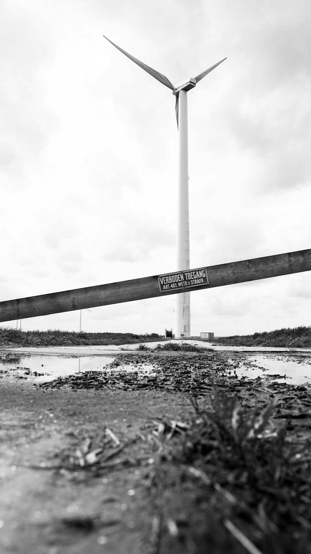 a black and white photo of a wind turbine