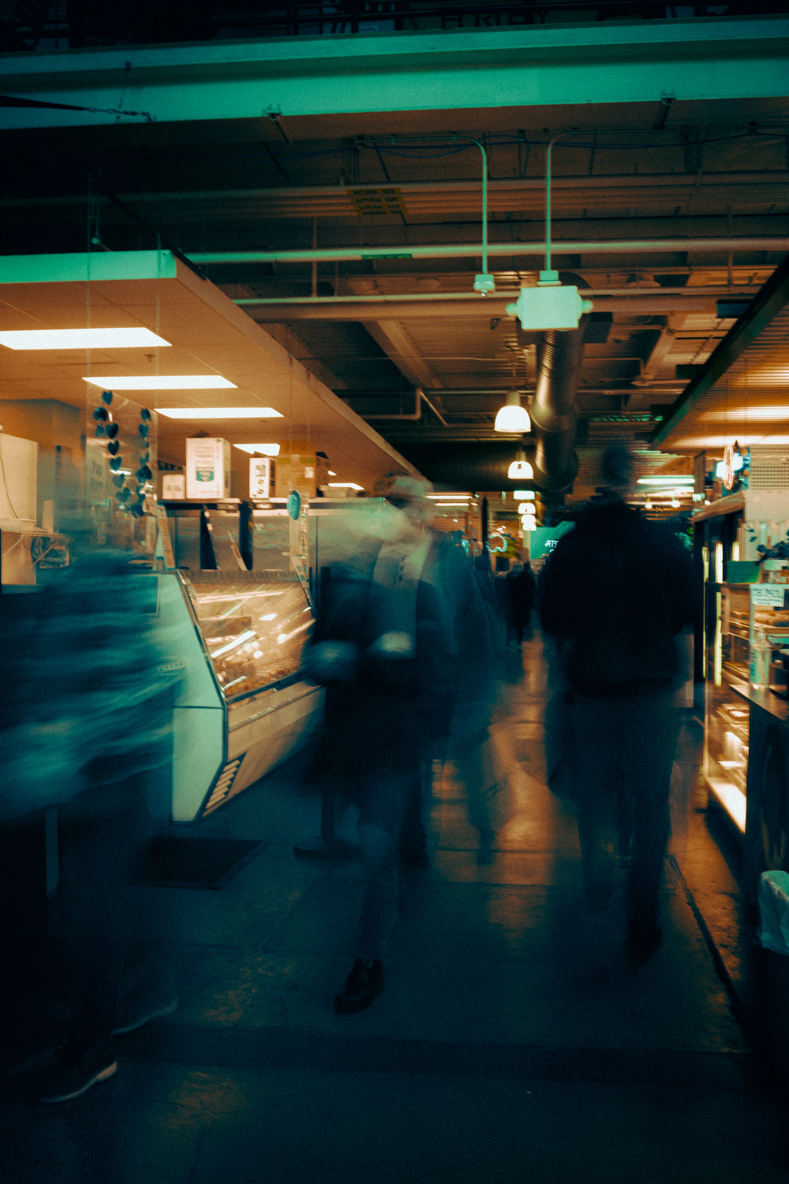 A blurred group of people walking quickly through a hallway