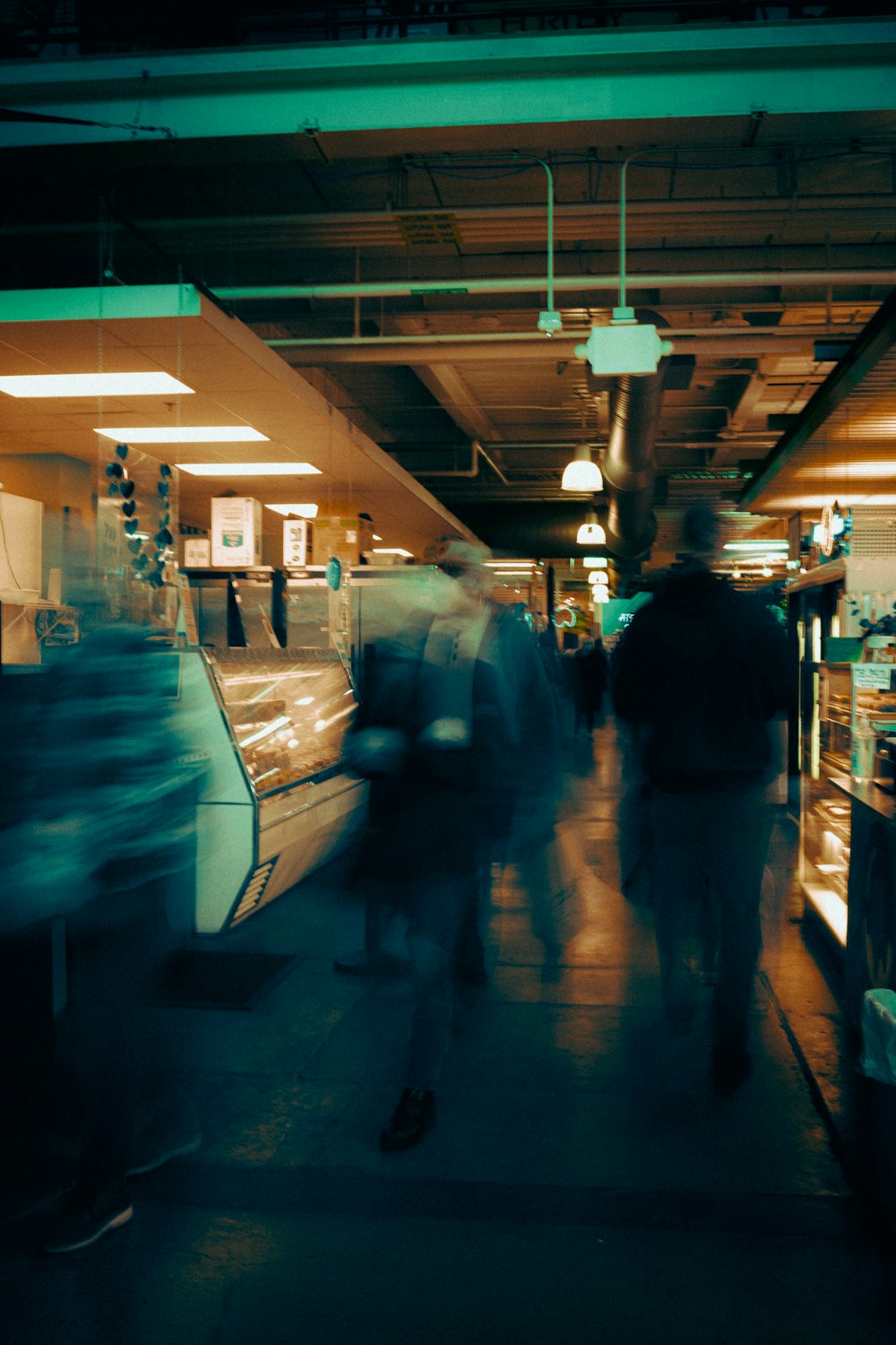 a group of people walking down a long hallway