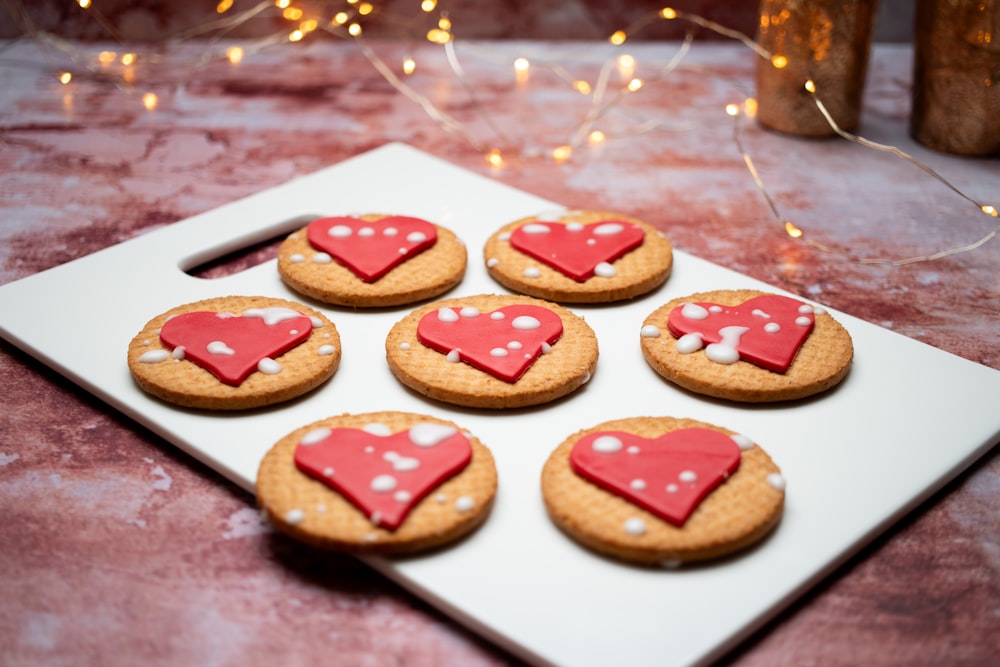 a white plate topped with cookies covered in frosting