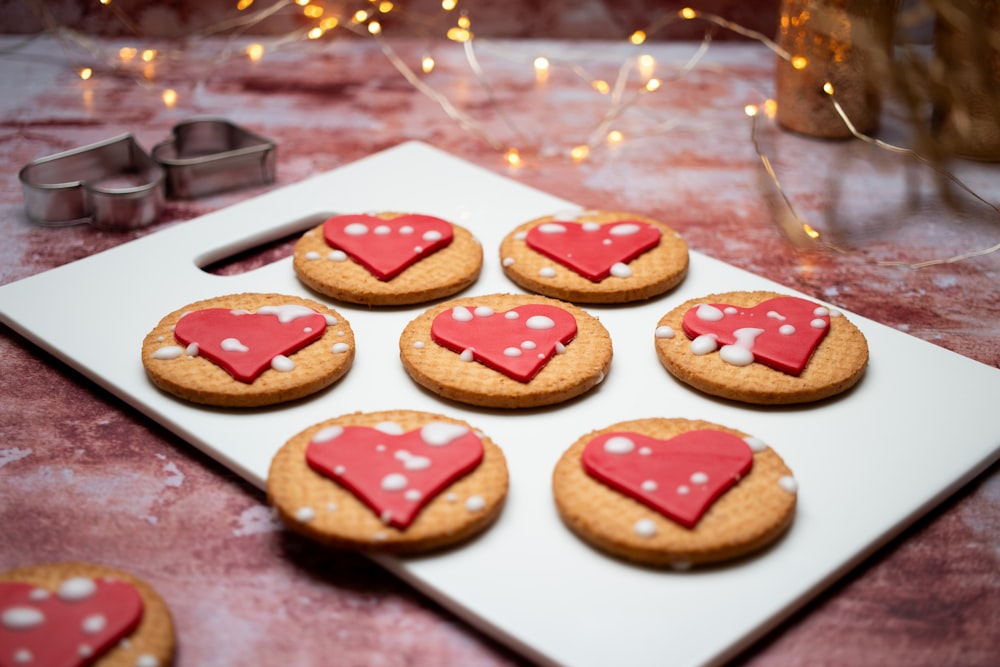 a tray of heart shaped cookies on a table