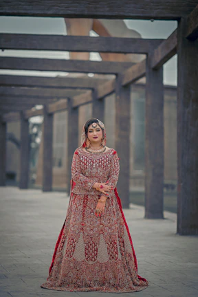 a woman in a red and gold wedding dress