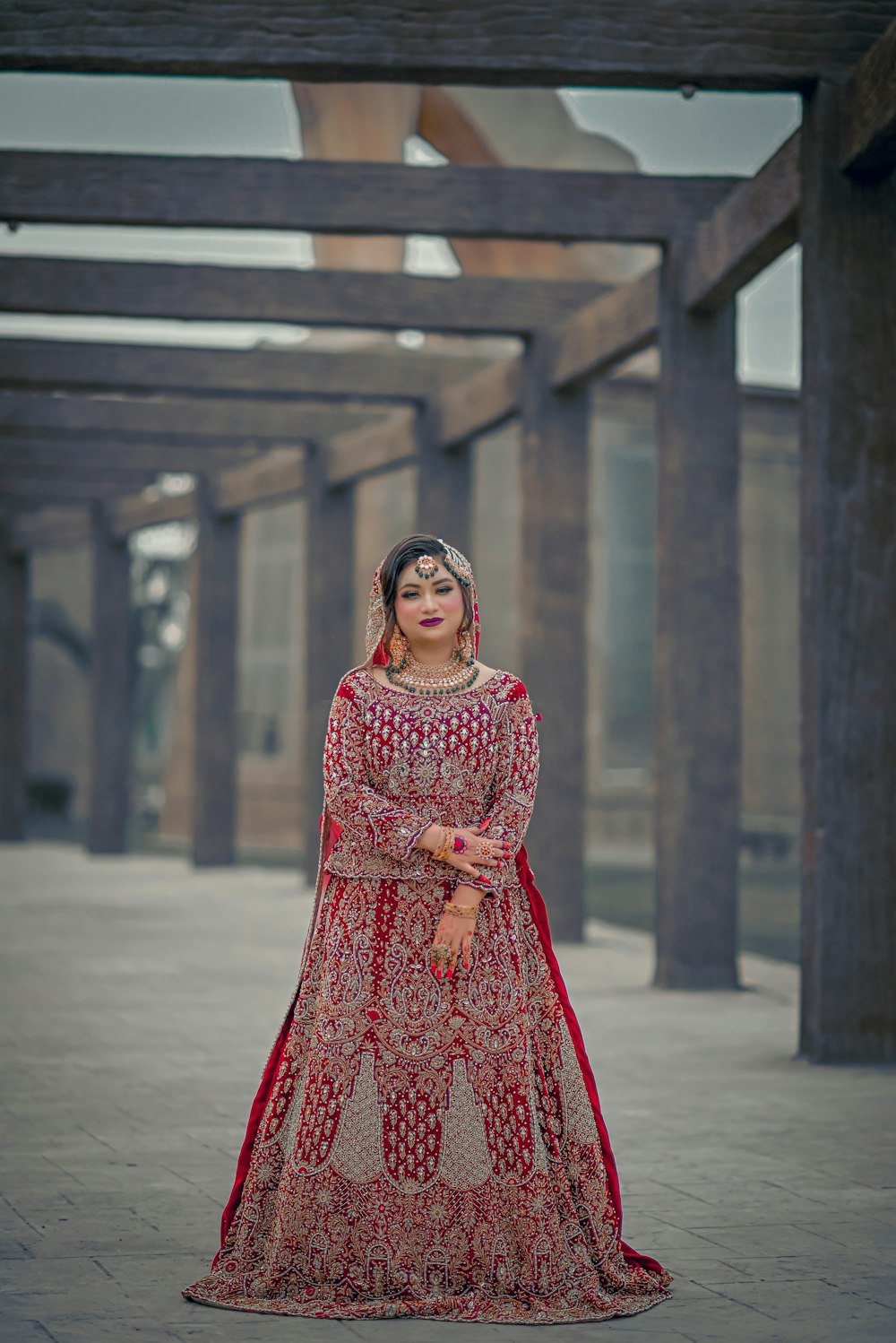 a woman in a red and gold wedding dress