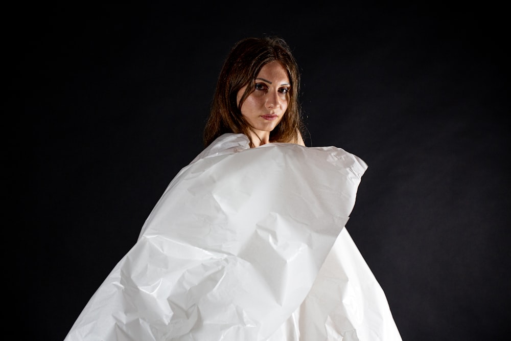 a woman holding a white piece of paper